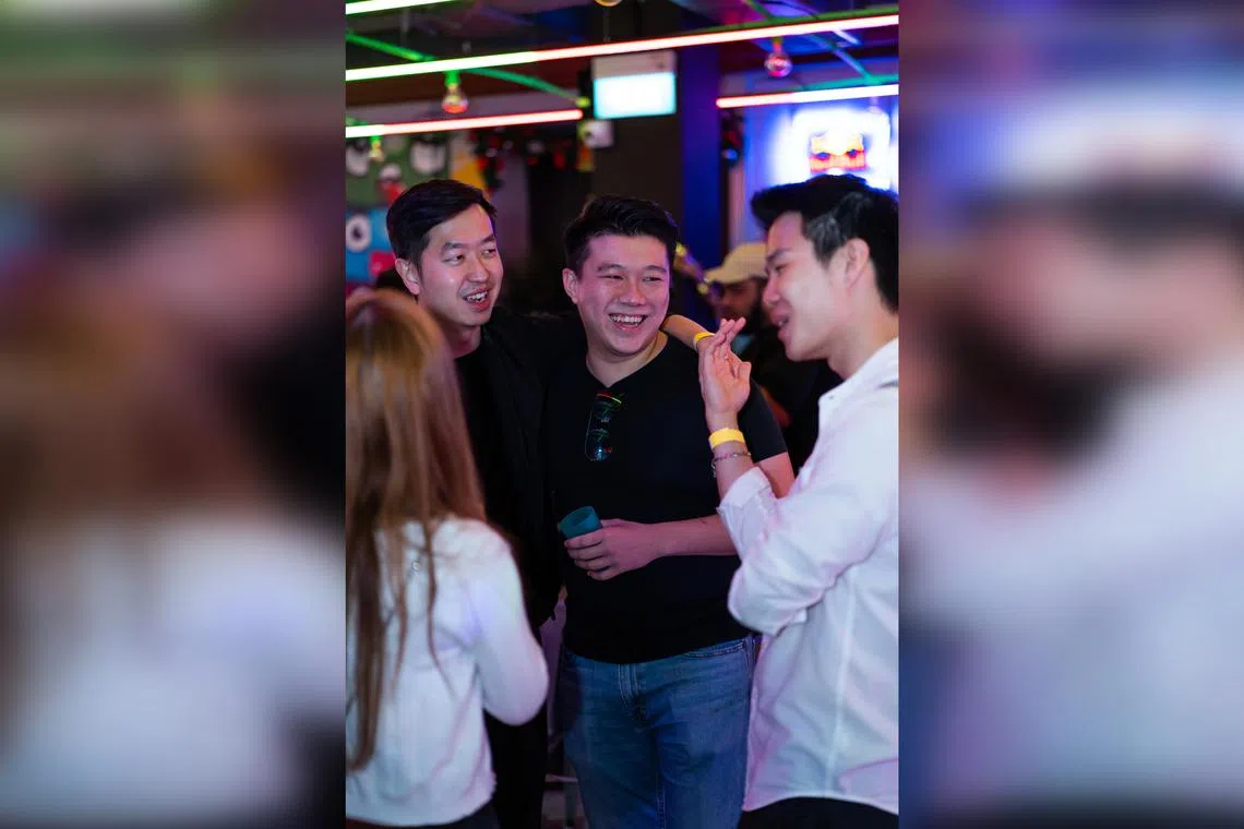 Mr Joshua Yap (centre), founder of non-fungible token ticketing app CrowdServe, at a bar in Clarke Quay. 