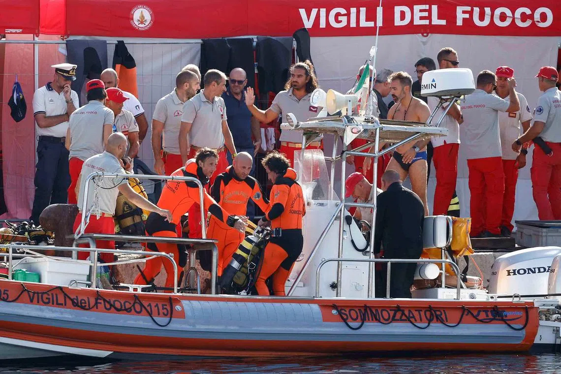 Rescue personnel operate at a port to search for the missing, including British entrepreneur Mike Lynch, after a luxury yacht sank off the coast of Porticello, near the Sicilian city of Palermo, Italy, August 21, 2024. REUTERS/Guglielmo Mangiapane