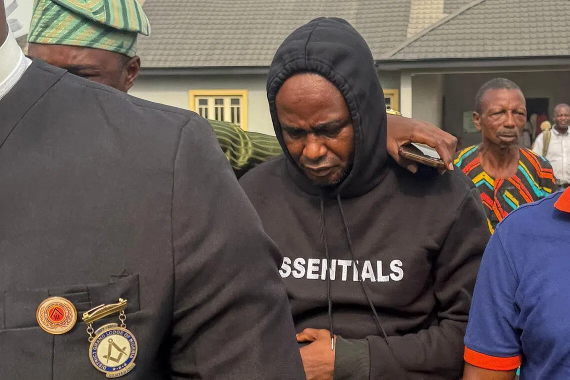 Adeniyi Mobolaji Kayode (C), the driver charged in the car crash that injured Anthony Joshua and killed his friends, walks at a court in Sagamu on January 20, 2026. Adeniyi Mobolaji Kayode, 46, was driving the former two-time heavyweight champion Joshua and two of his friends, Latif Ayodele and Sina Ghami when their Lexus SUV rammed into a stationary truck.
Kayode faces multiple reckless driving charges as well as a charge of driving without a license. (Photo by Tonye BAKARE / AFP)