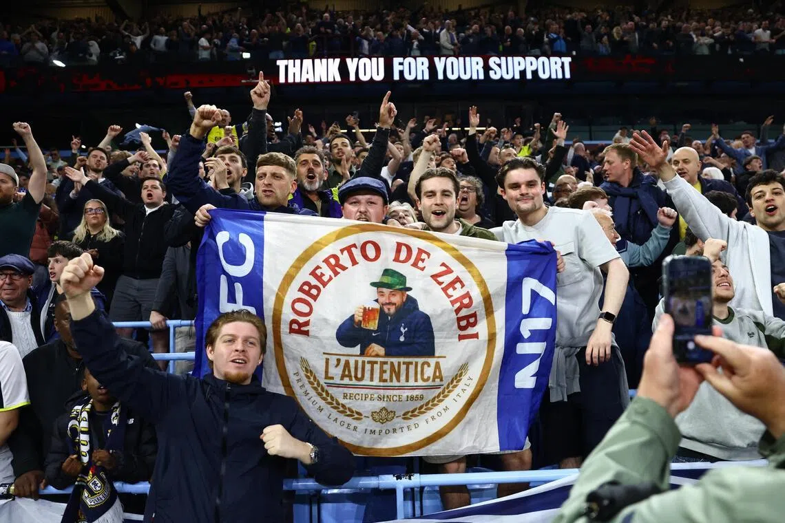 Tottenham Hotspur fans holding a banner in support of manager Roberto de Zerbi after their 2-1 win at Aston Villa on May 3, 2026, at Villa Park.