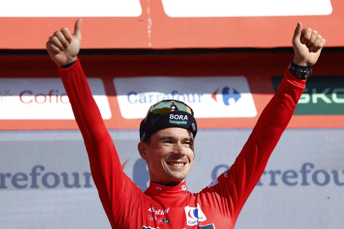 FILE PHOTO: Cycling - Vuelta a Espana - Stage 19 - Logrono to Alto de Moncalvillo - Spain - September 6, 2024 Red Bull - Bora - Hansgrohe's Primoz Roglic celebrates on the podium while wearing the red jersey after taking the overall race lead by winning stage 19 REUTERS/Vincent West/ File Photo