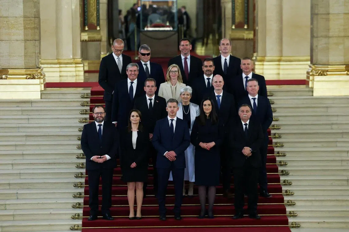 FILE PHOTO: Hungarian Prime Minister Peter Magyar and new members of government, Finance Minister Andras Karman, Minister of Regional and Rural Development Viktoria Lorinc, Foreign Minister Anita Orban, Minister for the Living Environment Laszlo Gajdos, PM's Chief of Staff Balint Ruff, Children and Education Minister Judit Lannert, Science and Technology Minister Zoltan Tanacs, Interior Minister Posfai Gabor, Economy and Energy Affairs Minister Istvan Kapitany, Justice Minister Marta Gorog, Agriculture and Food Minister Szabolcs Bona, Defence Minister Romulusz Ruszin-Szendi, Social Relations and Culture Minister Zoltan Tarr, Social and Family Affairs Minister Vilmos Katai-Nemeth,  Minister of Transport and Investment David Vitezy and Health Minister Zsolt Hegedus, pose for a family photo in the Parliament, in Budapest, Hungary, May 12, 2026. REUTERS/Bernadett Szabo/File photo
