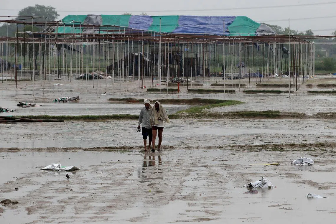 epa11454557 People walk at the scene after a stampede in Hathras, Uttar Pradesh, India, 03 July 2024. According to state officials, more than 120 people were killed in a stampede at a satsang Hindu religious gathering in Hathras district in Uttar Pradesh state, northern India.  EPA-EFE/HARISH TYAGI