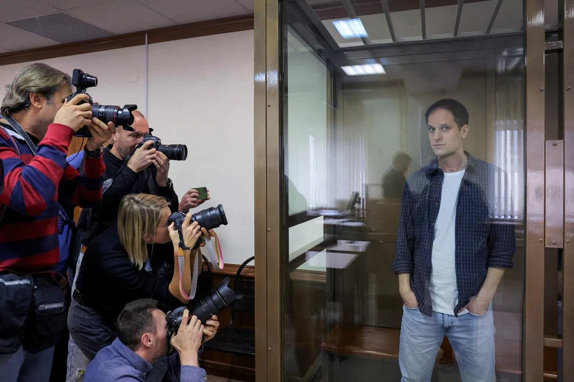 FILE PHOTO: Wall Street Journal reporter Evan Gershkovich stands inside an enclosure for defendants before a court hearing to consider an appeal against his pre-trial detention on espionage charges in Moscow, Russia, October 10, 2023. REUTERS/Evgenia Novozhenina/File Photo