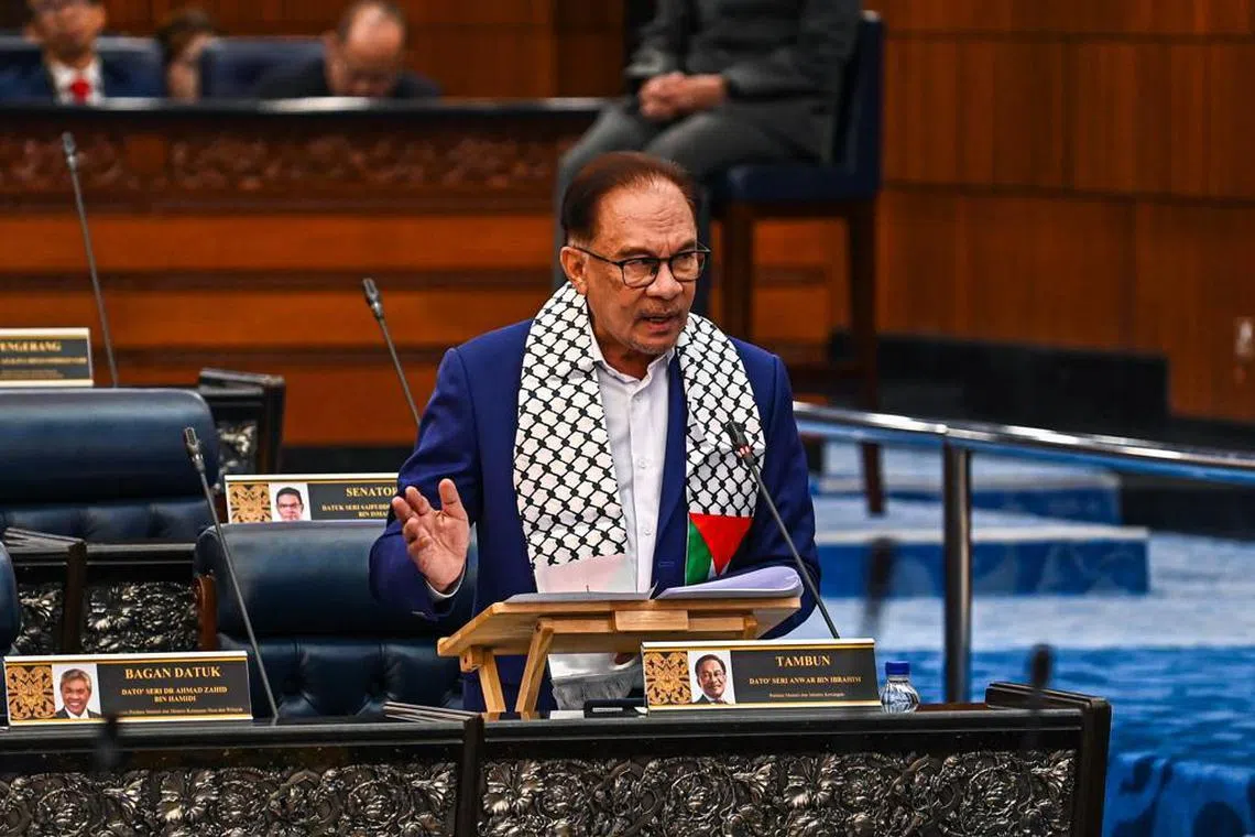 Malaysia Prime Minister Anwar Ibrahim, wearing a Palestinian scarf known as a keffiyeh, in Parliament on Monday. Malaysia has rejected Western pressure to condemn Hamas.
