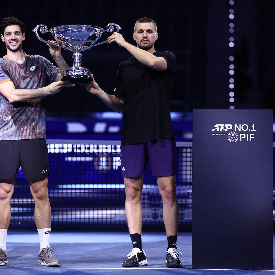 Tennis - ATP Finals - Turin - Palasport Olimpico, Turin, Italy - November 11, 2025 Britain's Julian Cash and Lloyd Glasspool pose with the ATP Doubles of the Year trophy REUTERS/Guglielmo Mangiapane