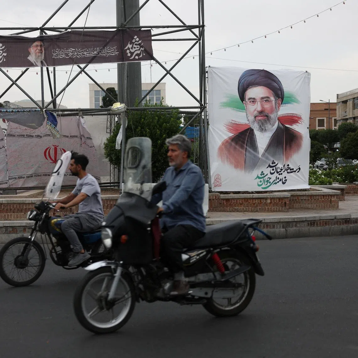 People ride near a banner with an image of Iran's Supreme Leader, Mojtaba Khamenei, on a street in Tehran, Iran June 7, 2026. Majid Asgaripour/WANA (West Asia News Agency) via REUTERS