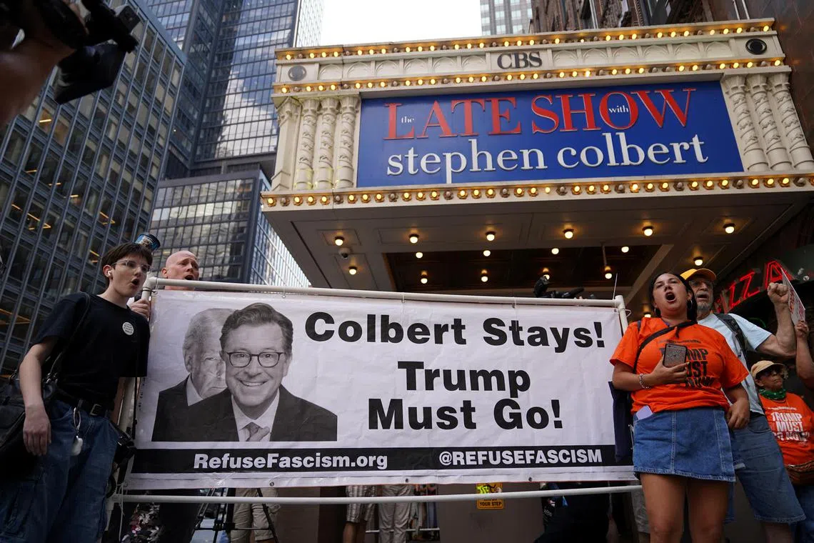 People protest after CBS/Paramount announced the cancellation of The Late Show with Stephen Colbert outside the Ed Sullivan Theater, in New York City, on July 21.