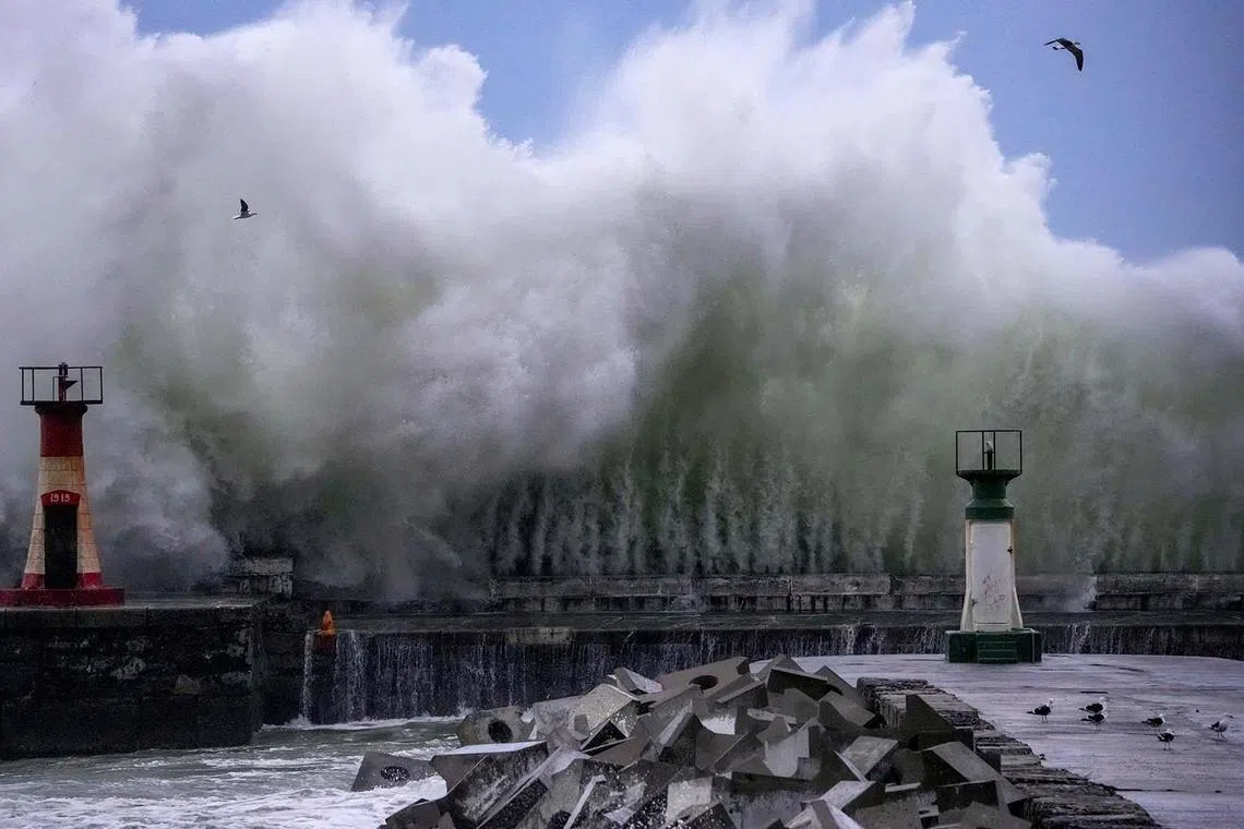 A storm swell breaks over Kalk Bay harbour during severe weather in Cape Town, South Africa on Sept 25.