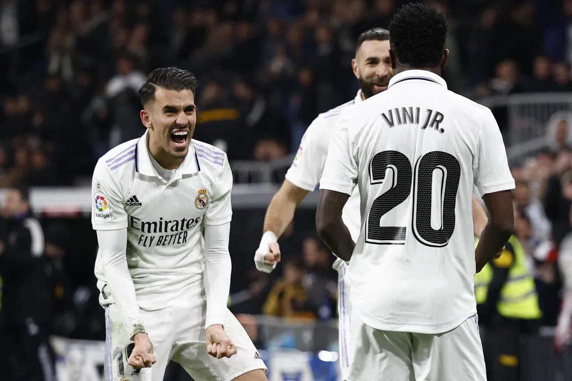 Real Madrid's Vinicius Junior celebrates scoring their second goal with teammates.