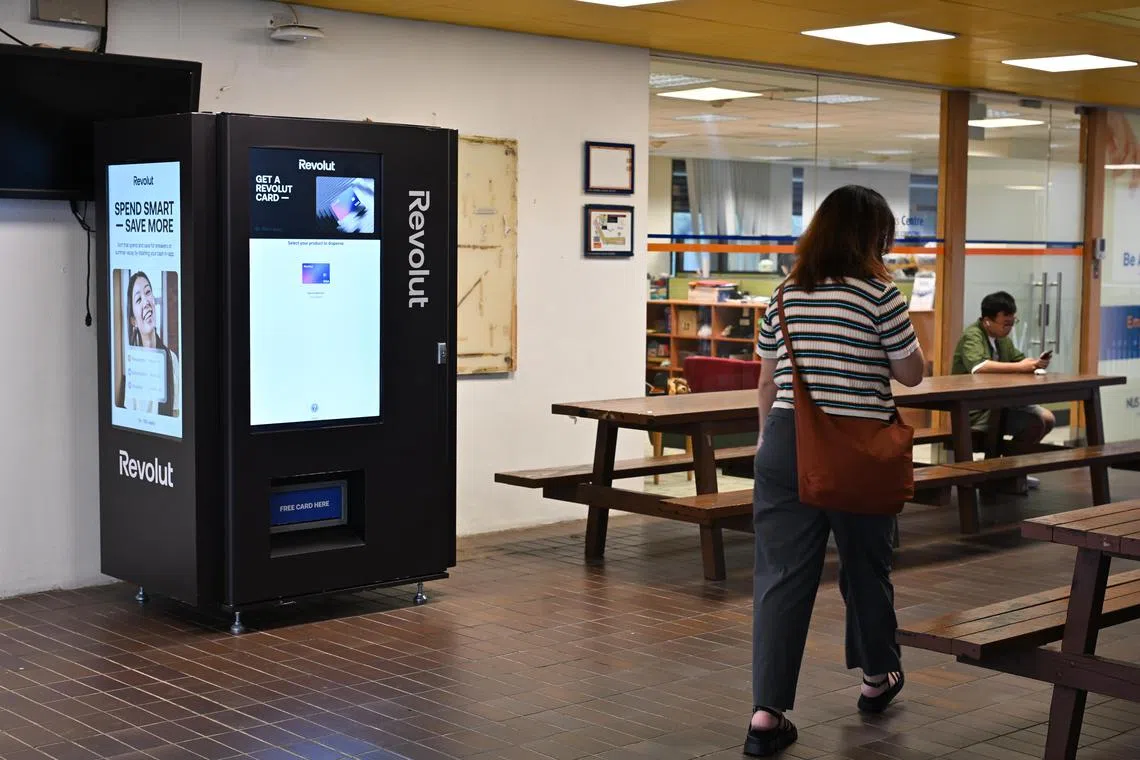 ST20241113-202484800231-Lim Yaohui-pixnuscard/
Revolut debit card vending machine outside NUS Business Analytics Centre at BIZ2 Level 4 in NUS on Nov 13, 2024.
Revolut, the global fintech with more than 45 million customers worldwide has unveiled an innovative way for customers to get their physical debit cards with a first-of-its-kind vending machine located at the National University of Singapore (NUS).
These Revolut cards are exclusively in partnership with Visa, a world leader in digital payments, enabling customers to enjoy the vast acceptance of Visa’s network - across 200 countries and by over 100 million merchants worldwide.
(ST PHOTO: LIM YAOHUI)