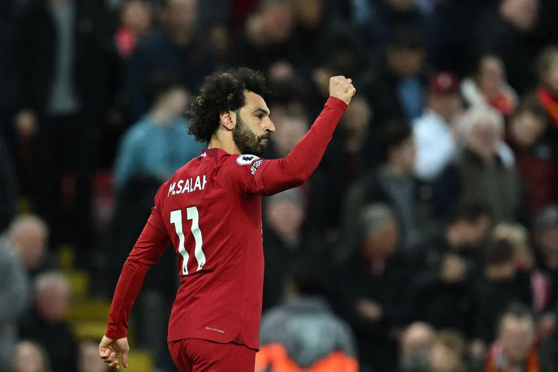 Liverpool's Mohamed Salah celebrates after scoring the winning goal from the penalty spot.