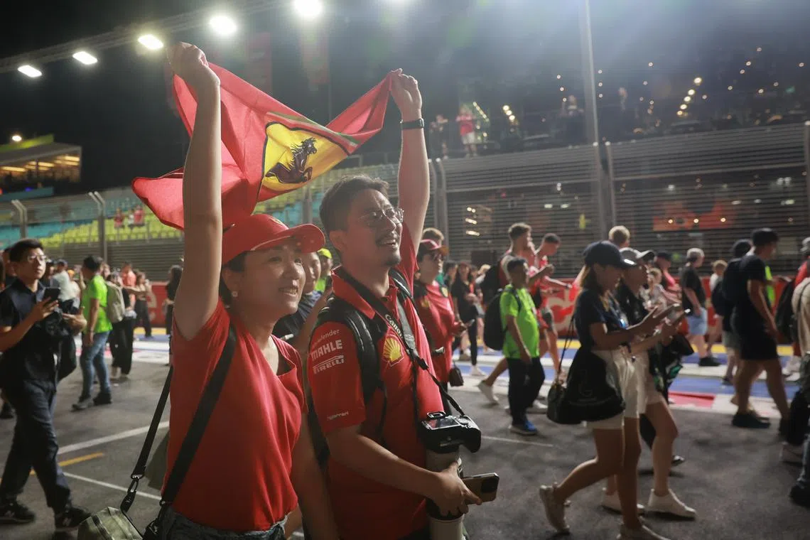 Fans holding Ferrari flag in celebration after Carlos Sainz of Scuderia Ferrari wins the Formula One Singapore Airlines Singapore Grand Prix at Marina Bay street circuit on Sept 17.