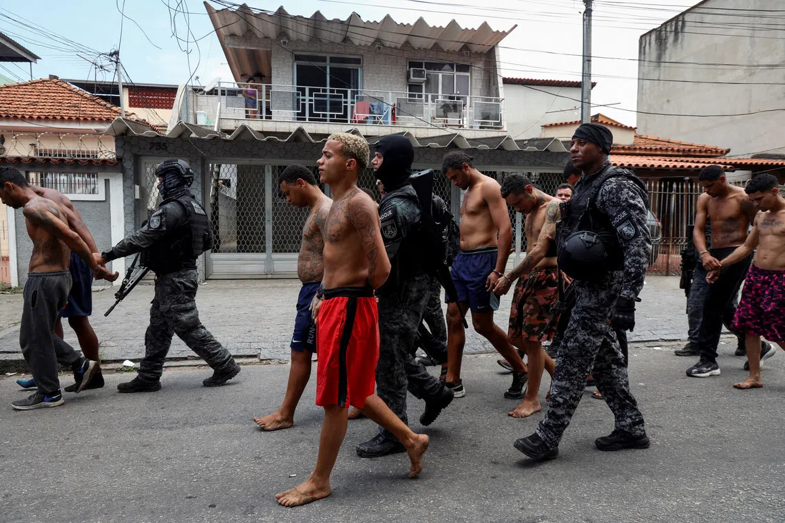 FILE PHOTO: Members of the military police special unit detain suspected drug dealers during a police operation against drug trafficking at a favela in the Penha slum complex, in Rio de Janeiro, Brazil October 28, 2025. REUTERS/Aline Massuca/File Photo
