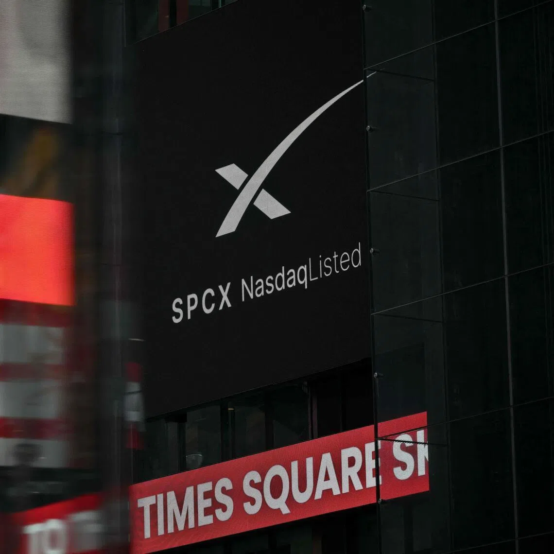 An advertisement for SpaceX is displayed on a screen at Times Square after the launch of SpaceX’s initial public offering (IPO) in New York on June 12, 2026. Shares in Elon Musk's SpaceX jumped as much as 30 per cent on their trading debut after the biggest IPO in history, making the polarising entrepreneur the world's first trillionaire as he vowed to take humanity to Mars. (Photo by ANGELA WEISS / AFP)