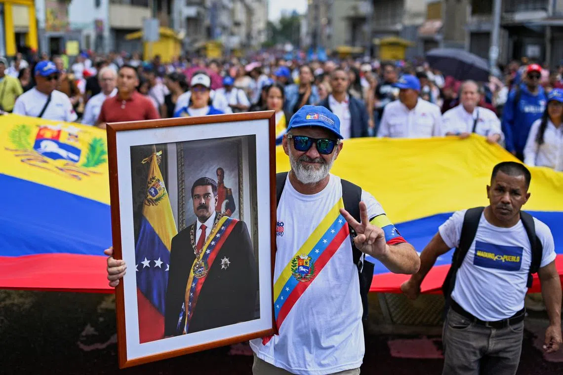 A demonstrator holds a portrait of Mr Maduro during a march outside the National Assembly on Jan 5.