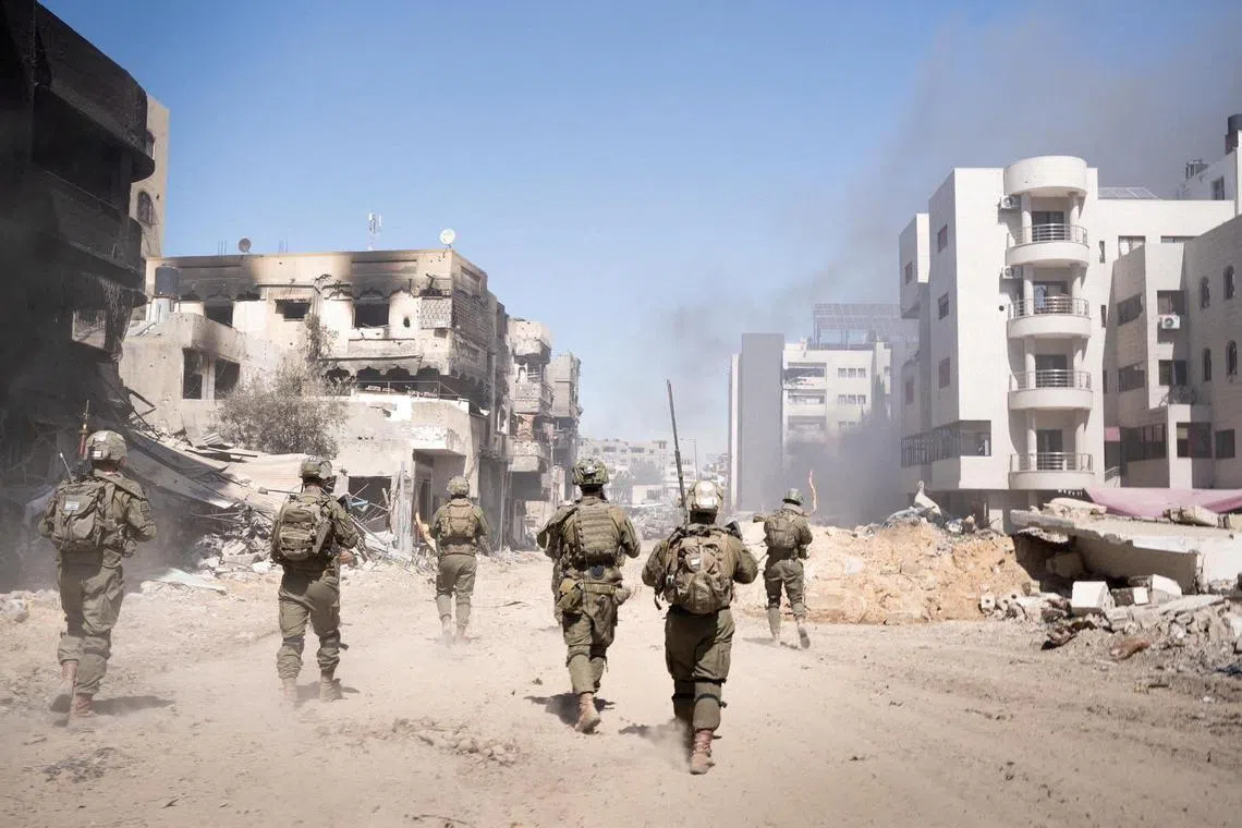 Israeli soldiers operate in the Gaza Strip amid the ongoing conflict between Israel and the Palestinian Islamist group Hamas, in this handout picture released on March 27, 2024.