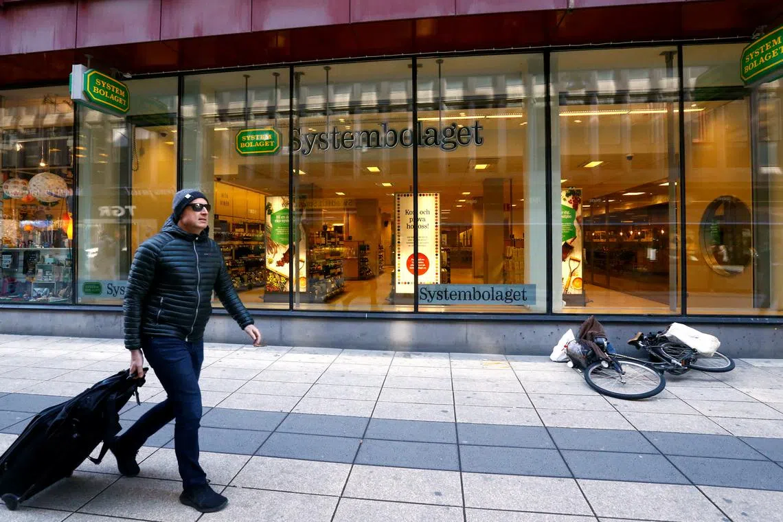 FILE PHOTO: A man walks past Systembolaget, a government-owned chain of liquor store and only retail store allowed to sell alcoholic beverages that contain more than 3.5% alcohol by volume, in Stockholm, Sweden, May 9, 2017. REUTERS/Ints Kalnins/File Photo
