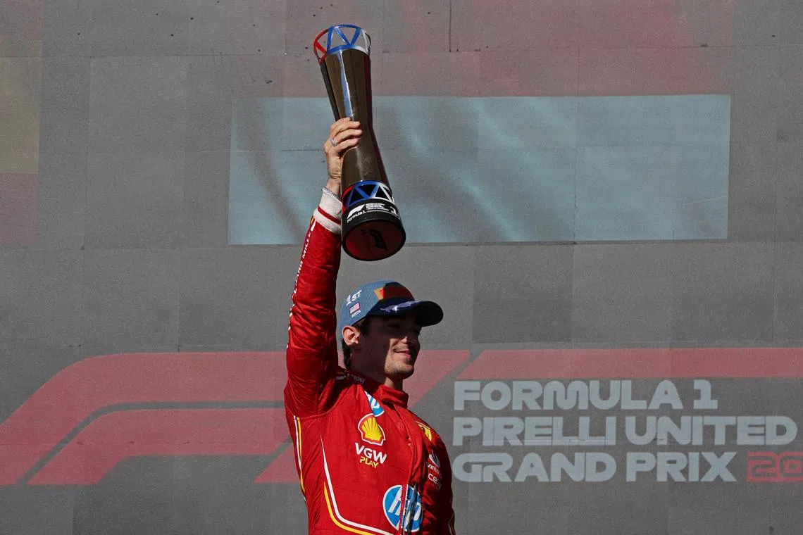 Formula One F1 - United States Grand Prix - Circuit of the Americas, Austin, Texas, United States - October 20, 2024 Ferrari's Charles Leclerc celebrates on the podium with a trophy after winning the United States Grand Prix REUTERS/Kaylee Greenlee Beal