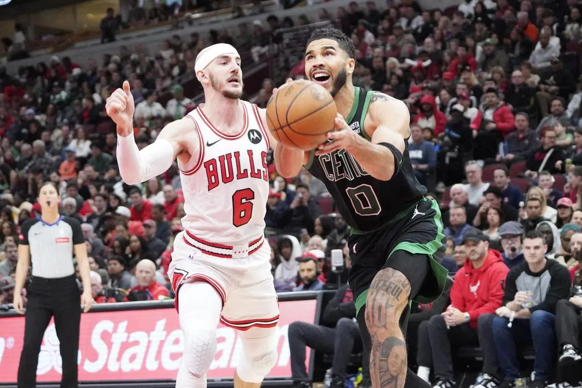 Chicago Bulls guard Alex Caruso (No. 6) defending Boston Celtics forward Jayson Tatum in a National Basketball Association game at United Centre on March 23. The Celtics won 124-113 on the night.