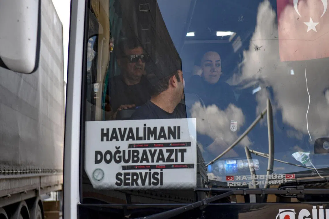 Members of the Iranian women's football team arriving by bus at Turkey's Gurbulak border crossing with Iran, on March 18.