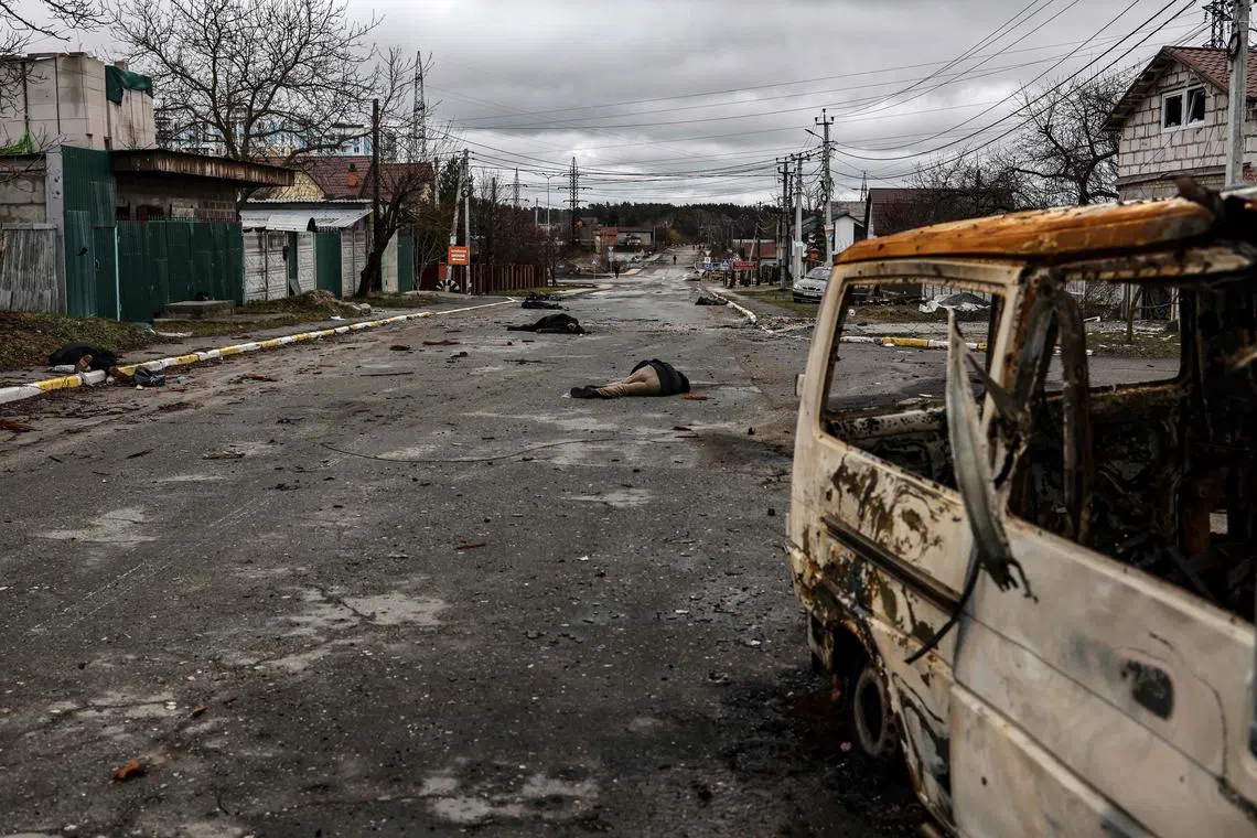 The bodies of civilians lie on a street in Bucha, north-west of Kyiv, after the Russian army's retreat from the city.
