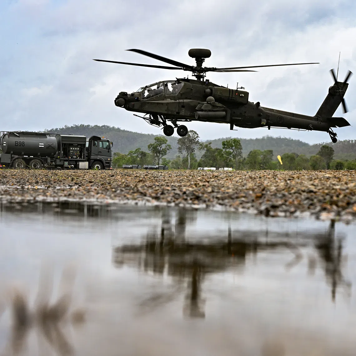 AH-64D Apache attack helicopter flying off after refueling next to the Bowser at Glen Airfield in the Shoalwater Bay Training Area in Queensland, Australia on Oct 24.