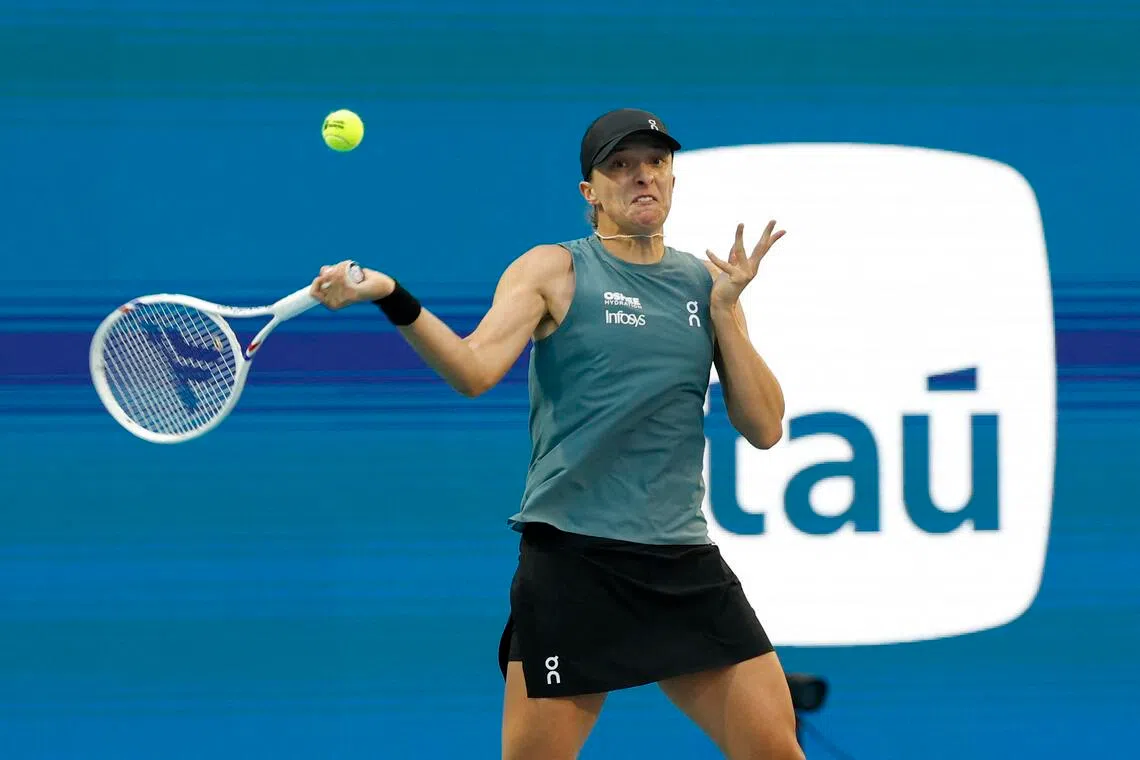 Iga Swiatek hitting a forehand against Magda Linette on day three of the 2026 Miami Open at Hard Rock Stadium. 