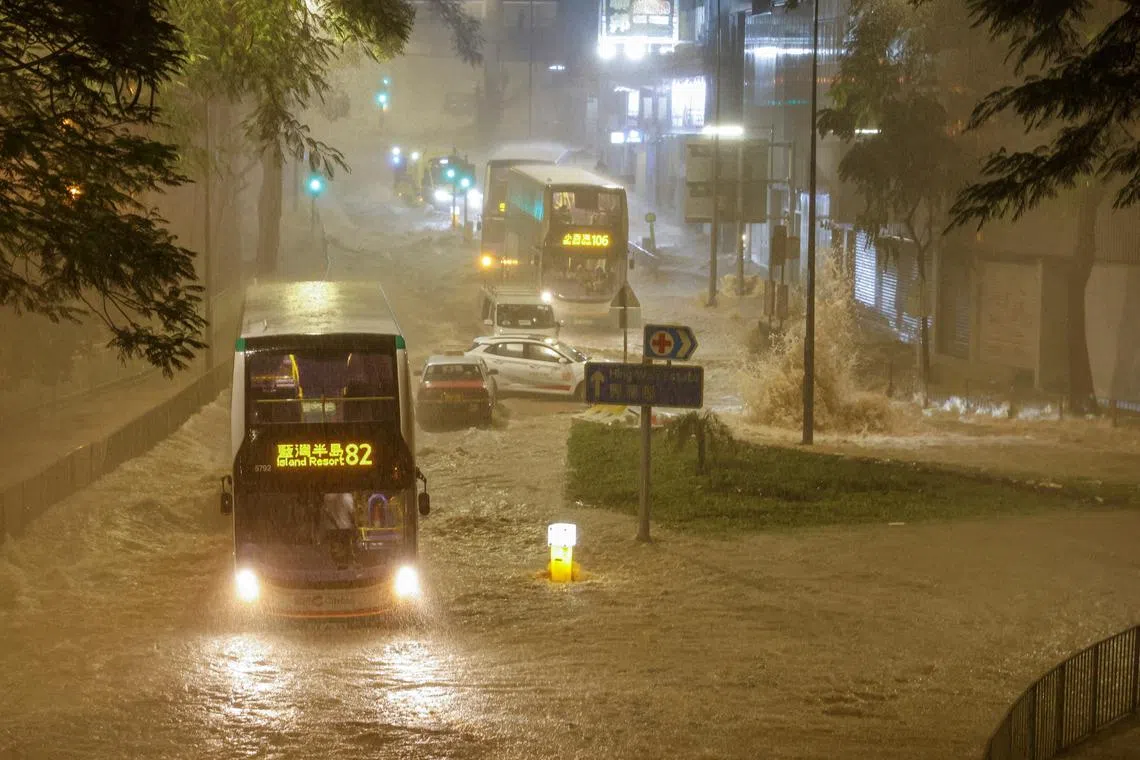 A bus driving past a flooded area during heavy rain, in Hong Kong, China, Sept 8, 2023. 