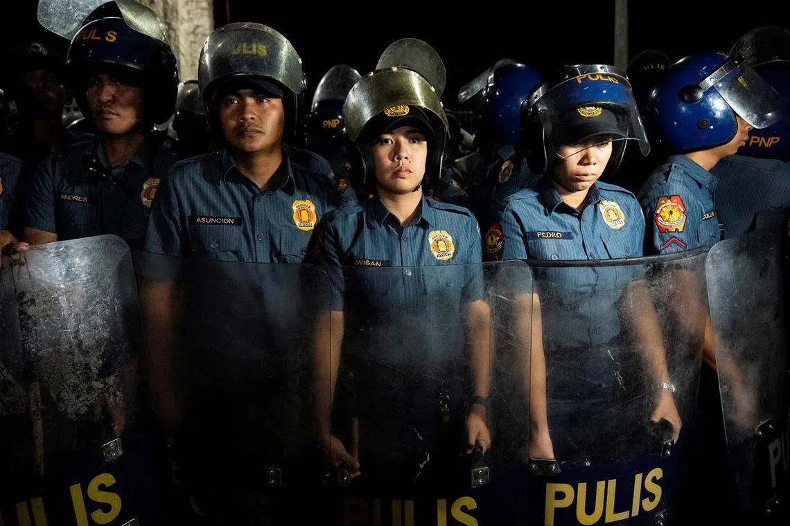Members of the Philippine National Police standing by outside the Villamor Airbase following the arrest of former Philippine President Rodrigo Duterte, in Pasay City, Manila, Philippines, March 11, 2025. 