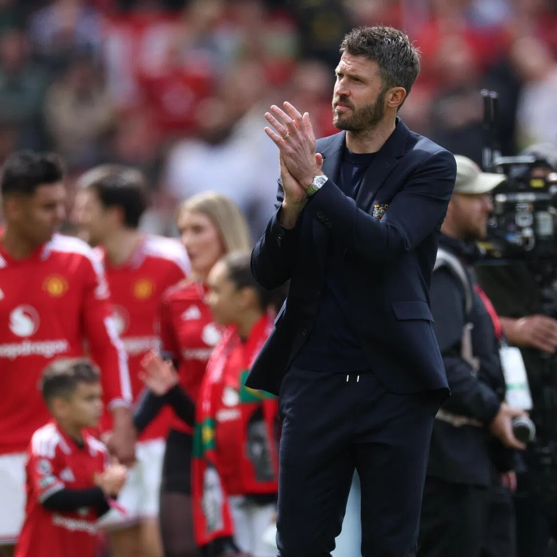 Manchester United manager Michael Carrick applauds fans after the Premier League match against Nottingham Forest.