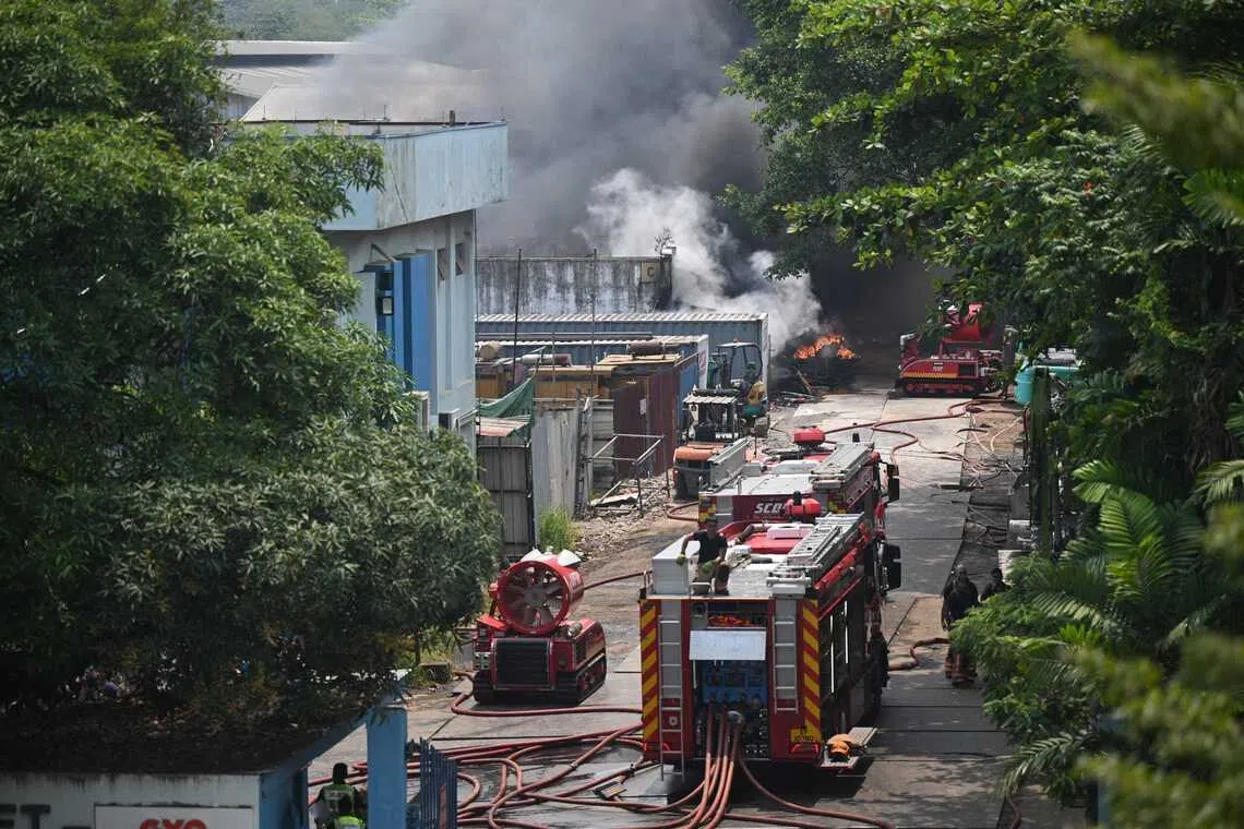 SCDF firefighters working to put out the fire at a warehouse at 10 Penjuru Road on Sept 8.