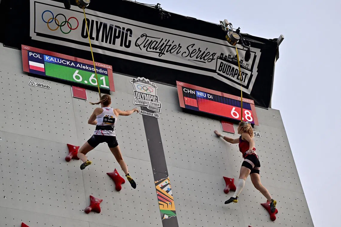 FILE PHOTO: Paris 2024 Olympics - Olympic Qualifier Series 2024 Budapest - Climbing  - Budapest, Hungary - June 22, 2024 Poland's Aleksandra Kalucka and China's di NIU in action during the women's speed climbing semifinals REUTERS/Marton Monus/File Photo