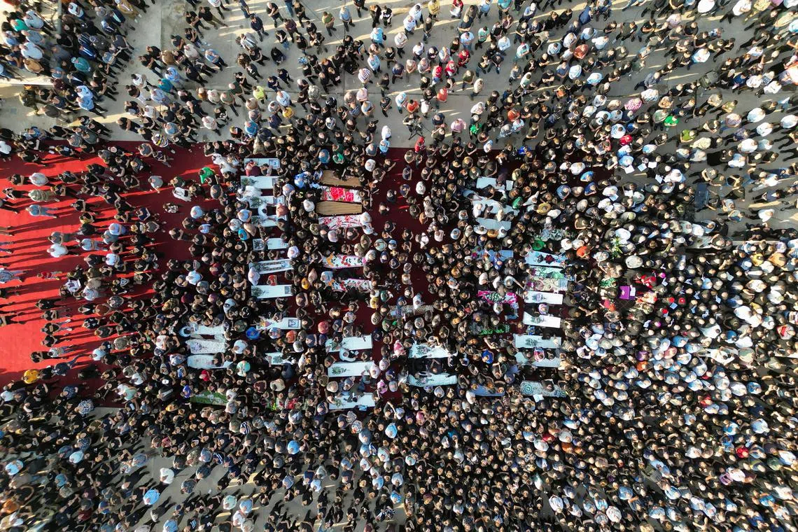 People attending the funeral of victims of the fatal fire of a wedding celebration, in Hamdanya, Iraq, Sept 27.