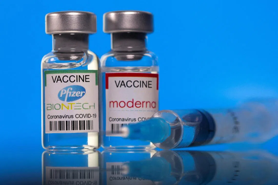 FILE PHOTO: Vials with Pfizer-BioNTech and Moderna coronavirus disease (COVID-19) vaccine labels are seen in this illustration picture taken March 19, 2021. REUTERS/Dado Ruvic/Illustration/File Photo