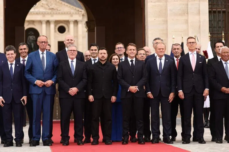 British Prime Minister Keir Starmer (centre left), French President Emmanuel Macron (centre right) and Ukrainian President Volodymyr Zelensky (centre) pose for a family picture with heads of states and governments before a summit of the Coalition of the Willing to support Ukraine in Paris on July 13, 2026.
