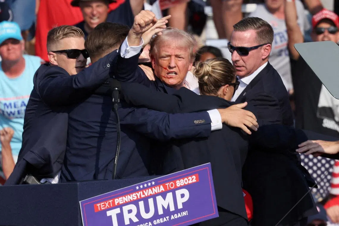 Former US President Donald Trump pumped his fist to the crowd, and then was rushed off the stage and ushered into his motorcade, which quickly left the venue.