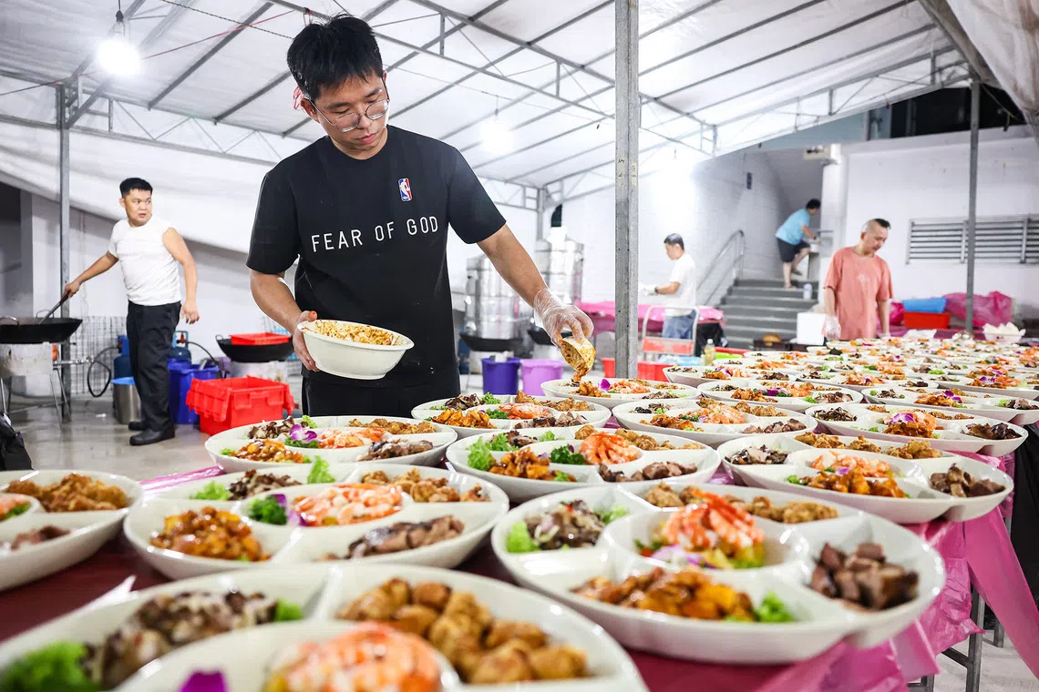 Staff of Gim Seng Heng Seafood Restaurant preparing the dishes ahead of the hungry ghost festival dinner auction at Toa Payoh on Aug 23, 2026. ST PHOTO: BRIAN TEO