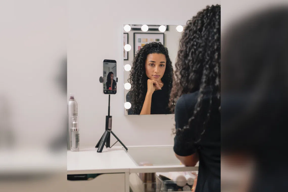 Influencer Eloise Dufka filming herself as she does her make-up at her vanity at home in New York on July 27.