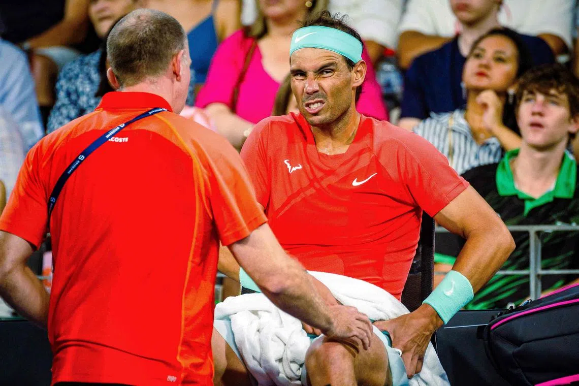 Spain's Rafael Nadal receiving medical treatment for his hip during the third set of his  5-7, 7-6 (8-6), 6-3 loss to Australia's Jordan Thompson at the Brisbane International tennis tournament in Brisbane on Jan 5.