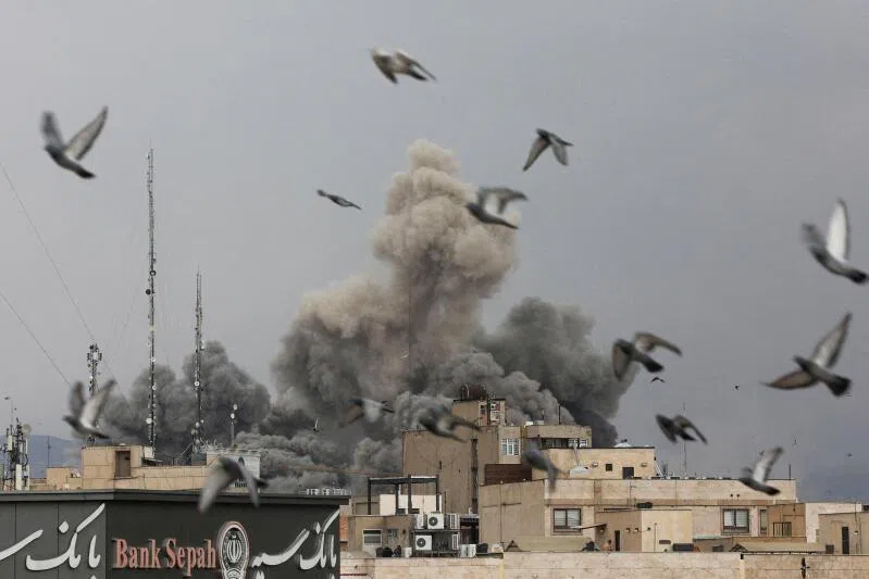 Birds fly as smoke rises following an explosion, after Israel and the U.S. launched strikes on Iran, in Tehran, Iran, on March 2, 2026. 