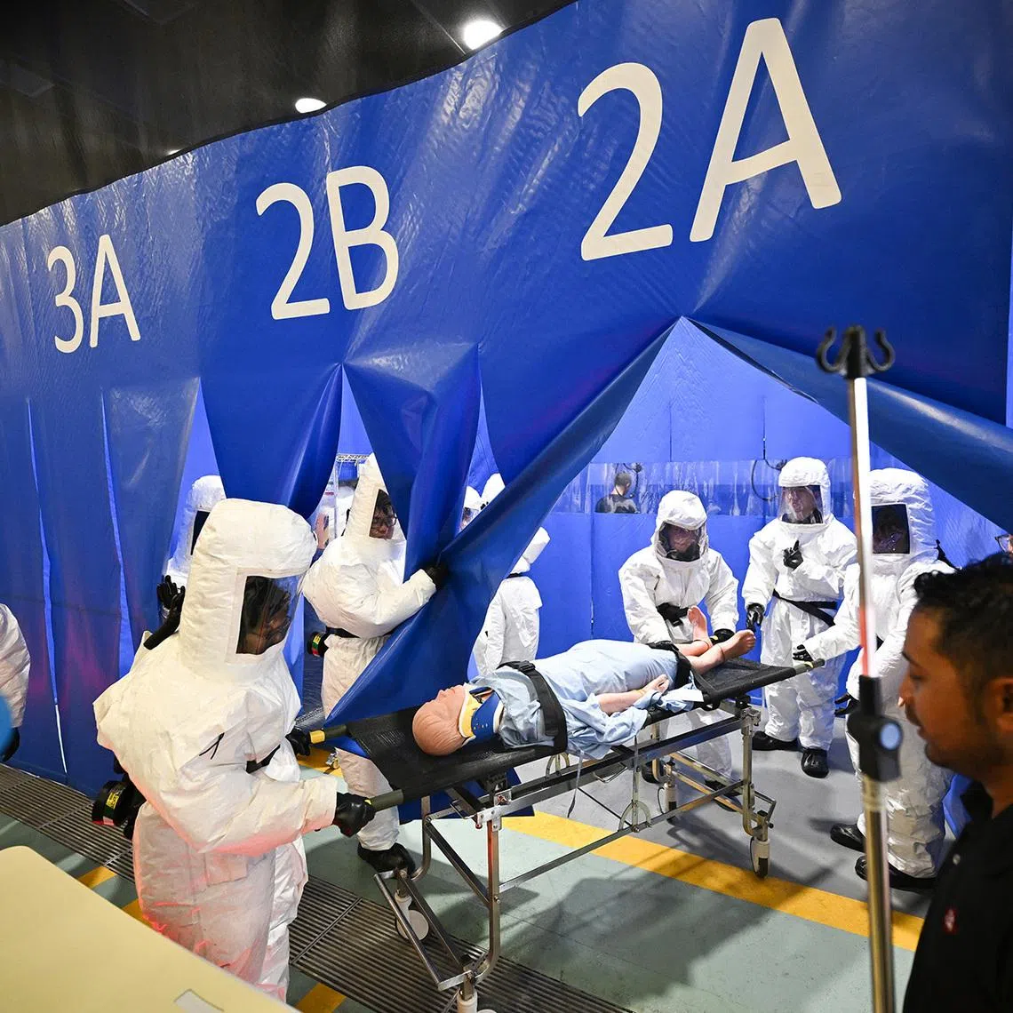 ST20250220-202527600732-Lim Yaohui-yhemergency/

Training for SGH Campus staff who volunteer to be part of the Hospital Decontamination Station (HDS) team at the new HDS located at level 3 of the new Emergency Medicine/National Neuroscience Building on Feb 20, 2025. 

Singapore General Hospital is getting a new emergency medicine building, expected to be completed in mid-2025, to replace the hospital's existing A&E facilities. The new 12-storey building will have about four times the space of the existing emergency facilities. The new building will be connected to the main hospital complex, as well as specialty centres to allow patients to benefit from a wider range of facilities and the pooled expertise of healthcare staff. The Straits Times executive photojournalist Lim Yaohui documents how staff are preparing for the opening of the new building and testing of the new facilities to cater for the increase in demand for emergency care in Singapore.

(ST PHOTO: LIM YAOHUI)