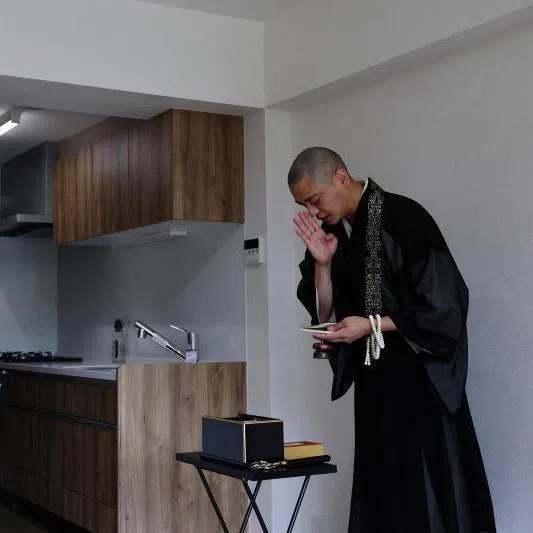 A Buddhist monk performing a ceremony for lost souls at a property which is classified as a “jiko bukken”, or “misfortunate property”, in Kawasaki, Japan.