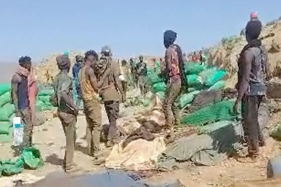 People inspecting the site of an airstrike in the mining area of Jabal al-Uqaydat, in Sudan, in a screengrab from a video obtained on Oct 12.