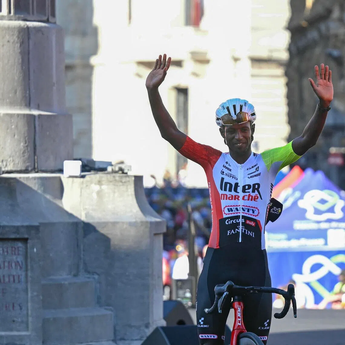 Biniam Girmay waving to spectators during the official teams' presentation ahead of the 2025 Tour de France in July.