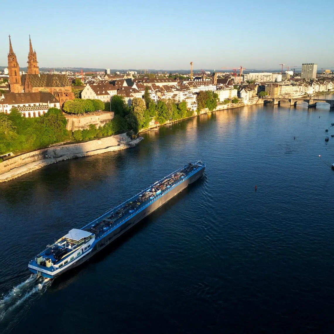 A drone view shows a barge on the Rhine river in front of the Muenster cathedral ahead of the Eurovision Song Contest in Basel, Switzerland, May 1, 2025. REUTERS/Denis Balibouse