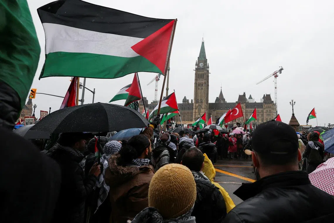 FILE PHOTO: Protesters hold Palestinian flags during a rally to call for a ceasefire, amid the ongoing conflict between Israel and the Palestinian Islamist group Hamas in Gaza, on Parliament Hill in Ottawa, Ontario, Canada March 9, 2024. REUTERS/Ismail Shakil/File Photo
