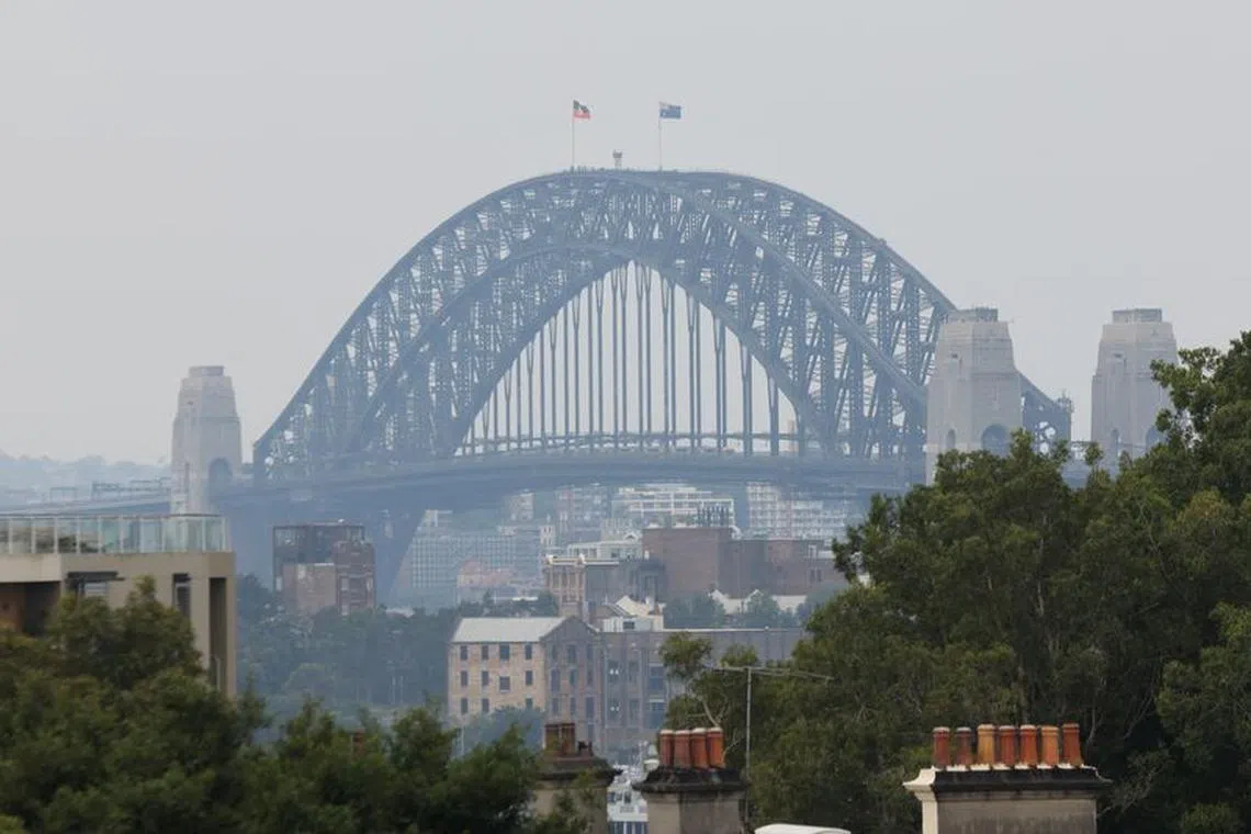 A view of the Sydney Harbour Bridge shrouded in smog from nearby bushfires in Sydney, Australia, December 19, 2023. REUTERS/Alasdair Pal