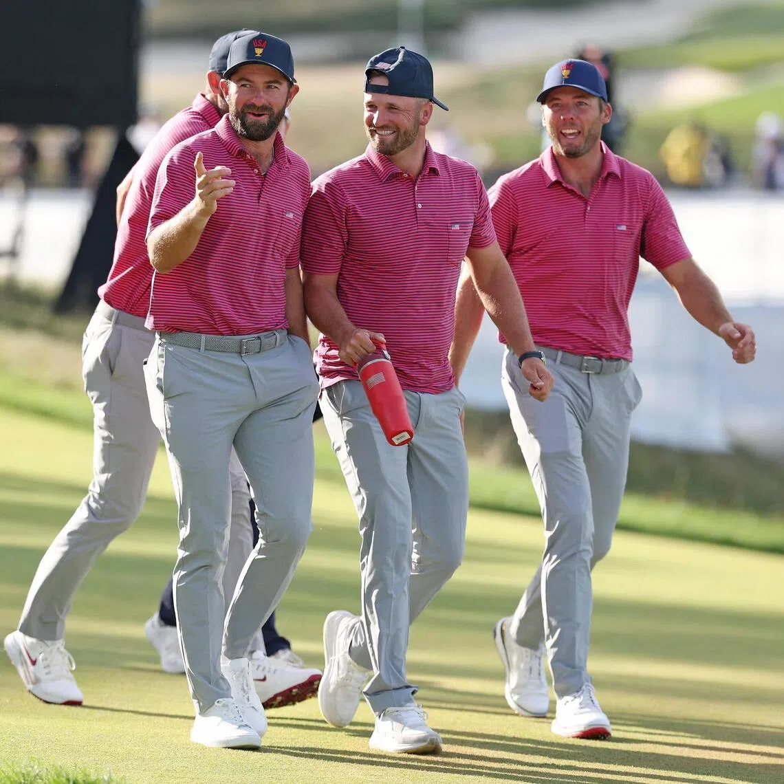 (From left) Americans Cameron Young, Wyndham Clark and Sam Burns reacting on the 18th hole on Sept 27.