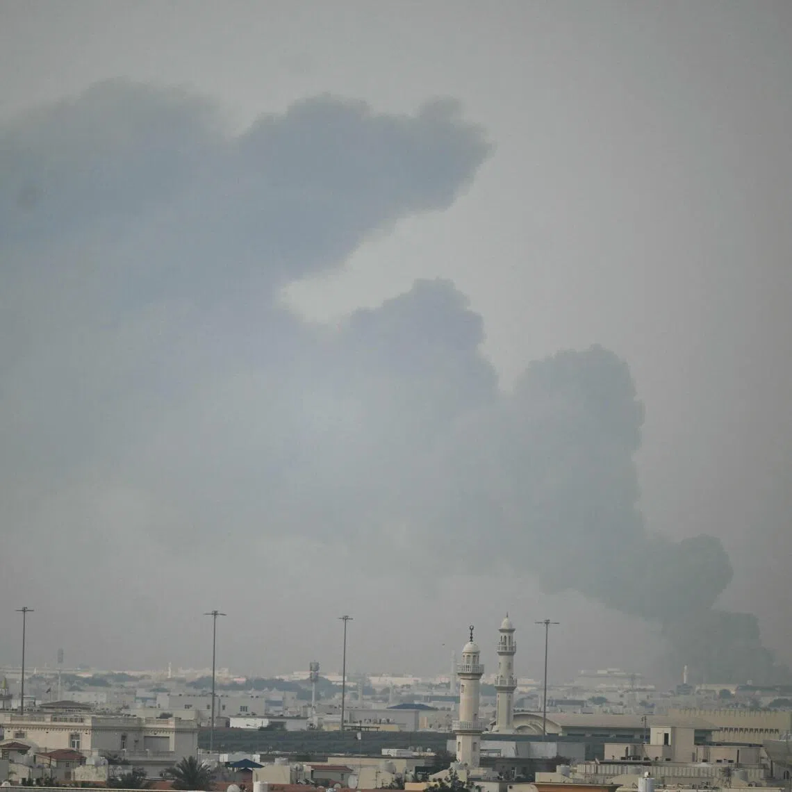 A plume of smoke rises following a reported Iranian strike in Doha on March 1, 2026.